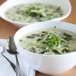 vegan cream of asparagus soup in white bowl