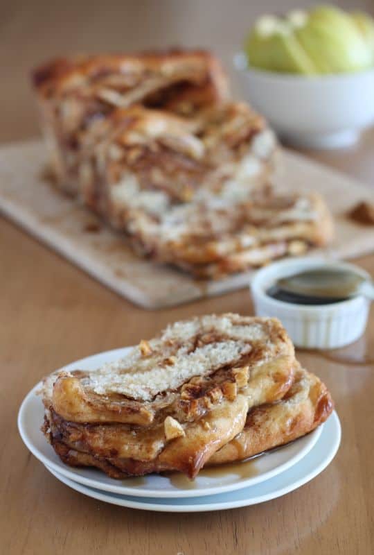 Vegan Caramel Apple Pull-apart Bread on white stacked plates with wood background