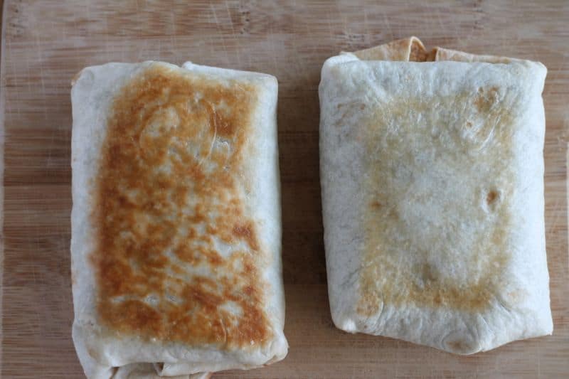 2 chimichangas side by side demonstrating difference between pan-fried (darker and crunchier) versus oven-baked