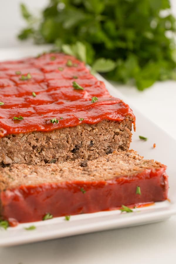 vegan meatloaf with maple tomato glaze on a white dish
